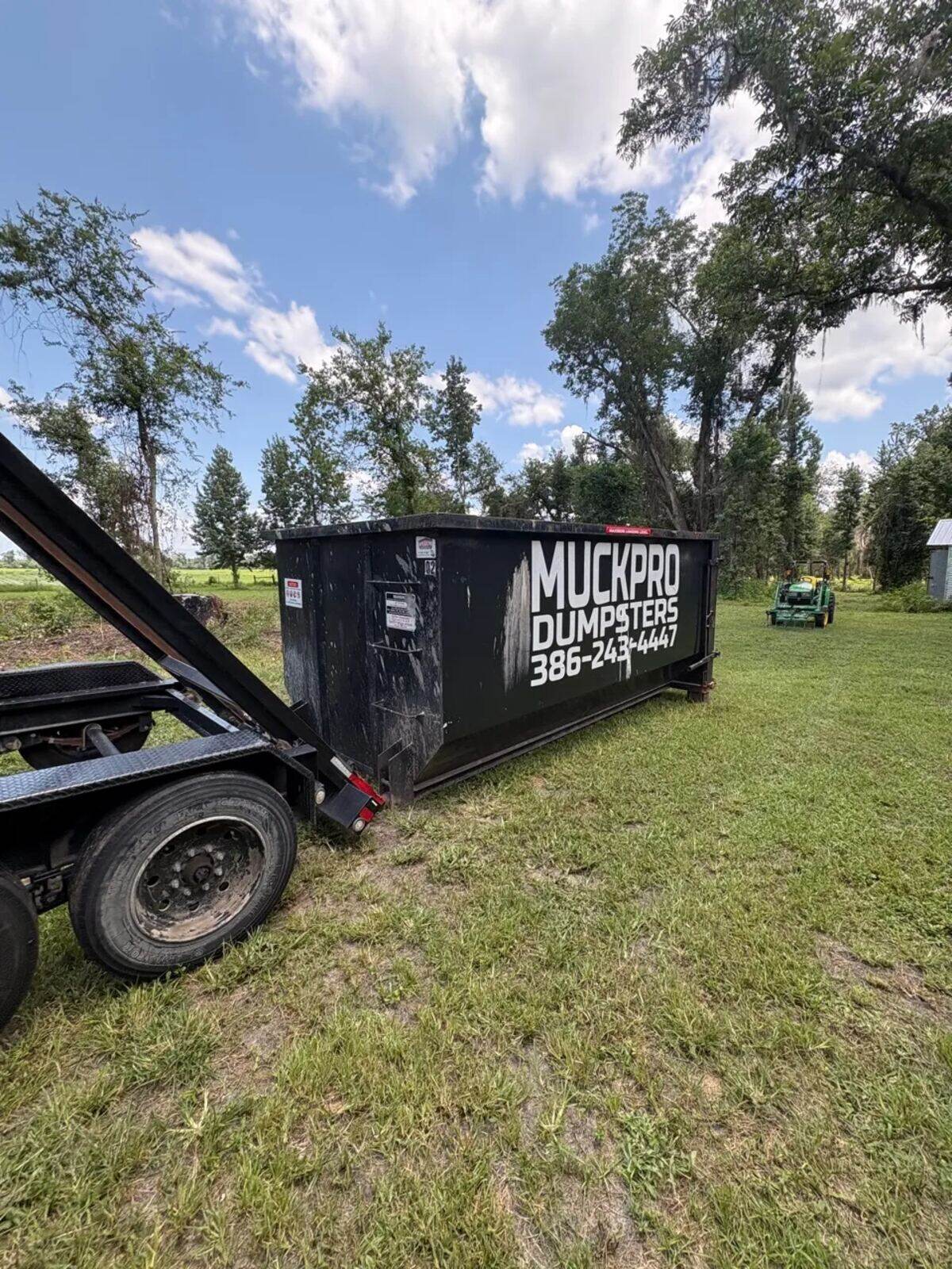 Muckpro roll-off dumpster placed at a rural North Florida property