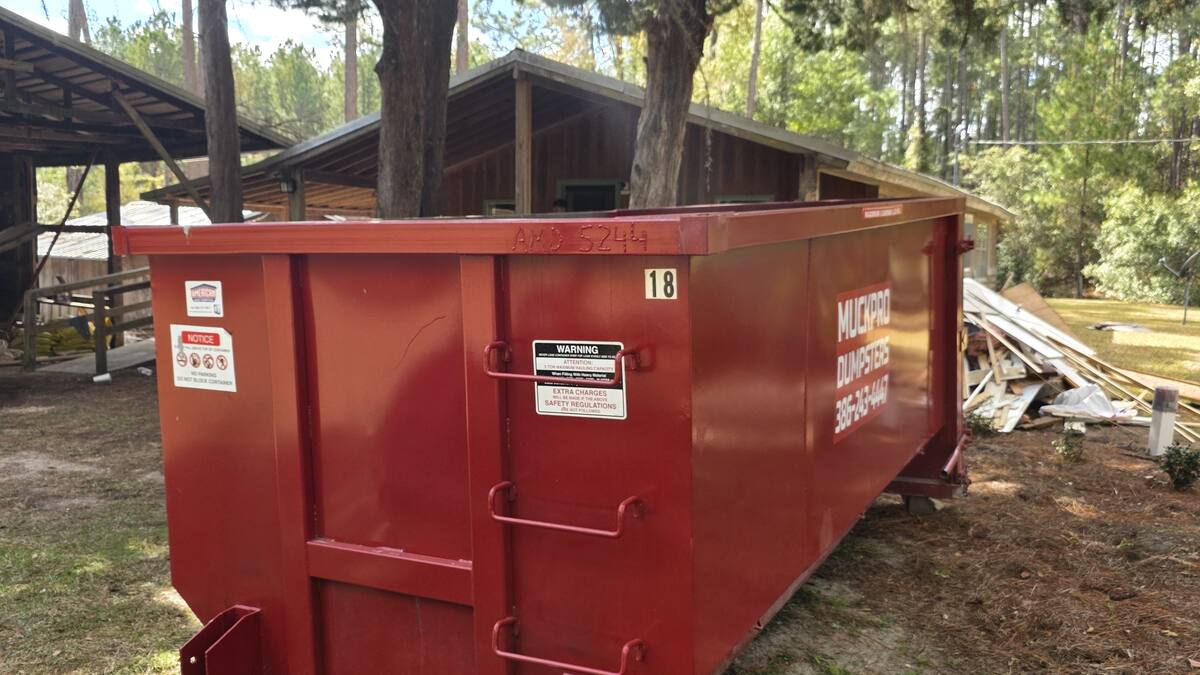 Muckpro roll-off dumpster placed at a home on the north side of Lake City, FL, off US 441 toward Osceola National Forest
