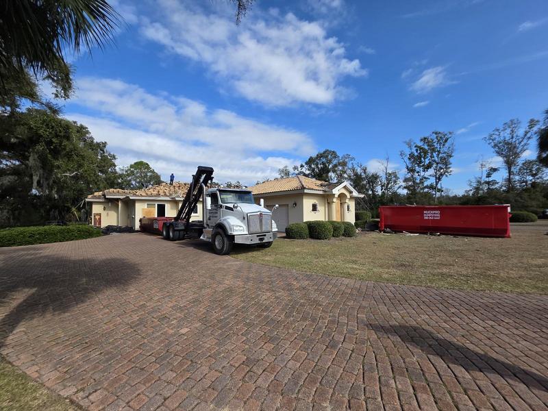 Muckpro dumpsters staged at a tile roof tear-off in Perry FL